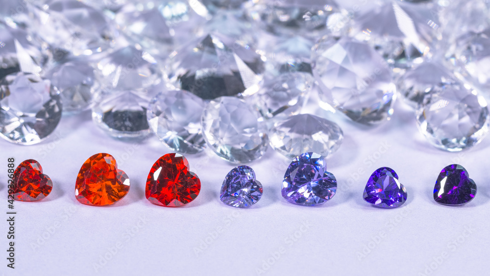 colorful diamond in heart shape are placed in a row on white diamonds background, colorful diamond in heart shape are placed in a row on white diamonds background,