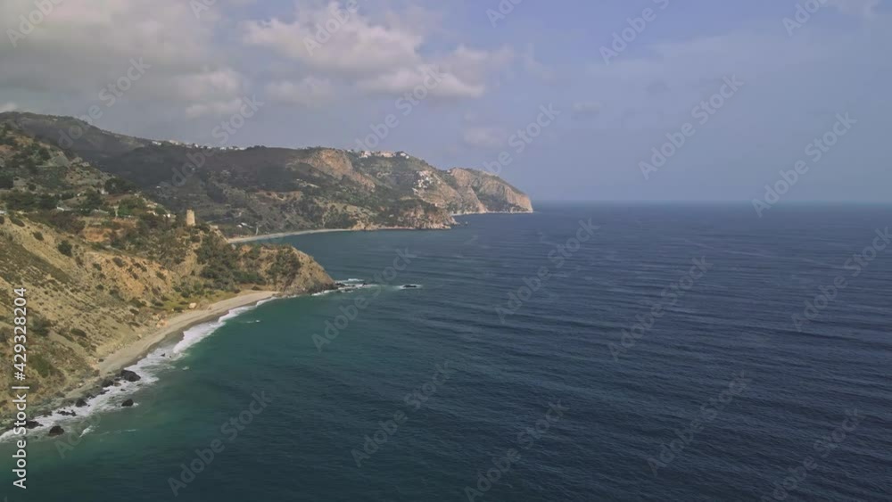 Coastline of Nerja, South of Spain, aerial view from the sea moving sideways near the shore Coastline of Nerja, South of Spain, aerial view from the sea moving sideways near the shore