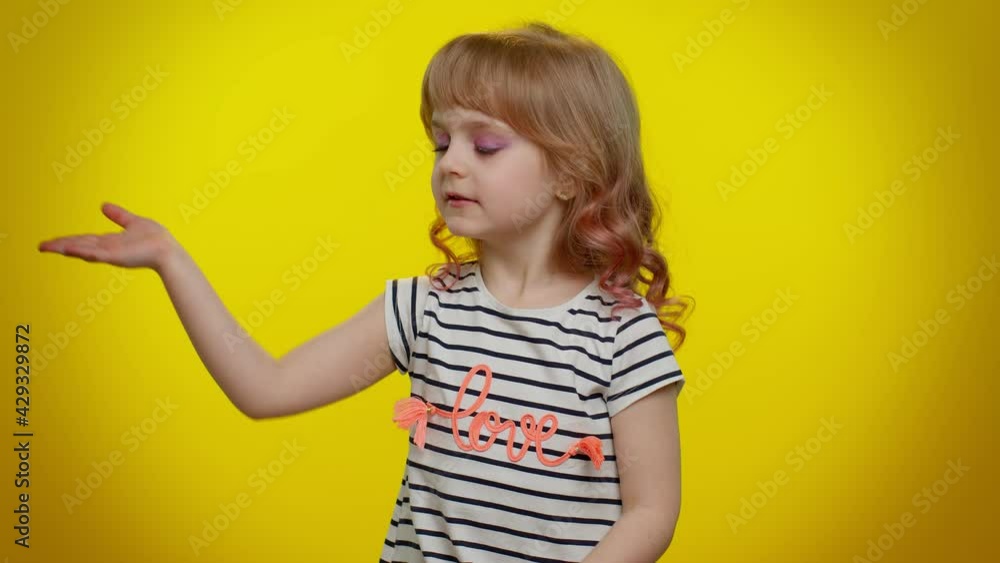 Smiling romantic blonde kid child 5-6 years old sending lots of air kisses looking at camera and smiling, missing you, love confession on yellow background. Teenager children girl lifestyle emotions Smiling romantic blonde kid child 5-6 years old sending lots of air kisses looking at camera and smiling, missing you, love confession on yellow background. Teenager children girl lifestyle emotions