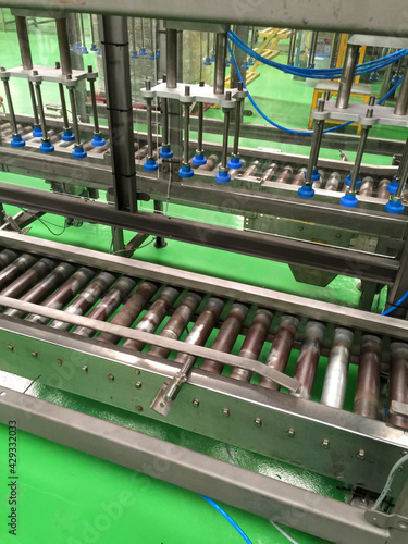 Conveyor belt of glass bottles into the drinking water filling process.