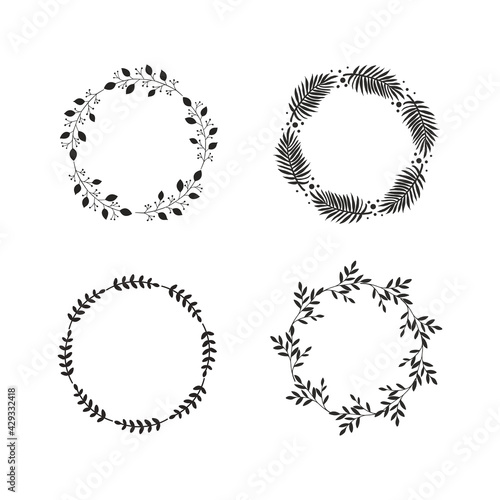 Four round vintage frames or wreaths of black branches with leaves on white background. Modern hand drawn floral design. Vector illustration 
