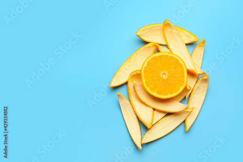 Fresh orange with peel on color background