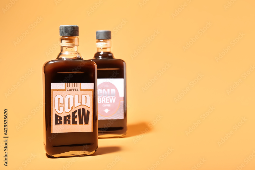Bottles of cold brew on color background Bottles of cold brew on color background