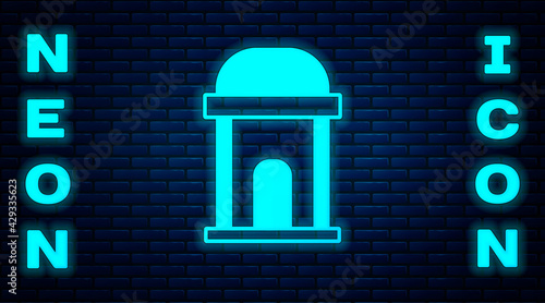 Glowing neon Old crypt icon isolated on brick wall background. Cemetery symbol. Ossuary or crypt for burial of deceased. Vector