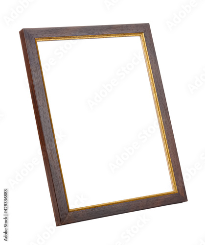Vertical standing empty dark brown wooden photo frame with golden border isolated on white background