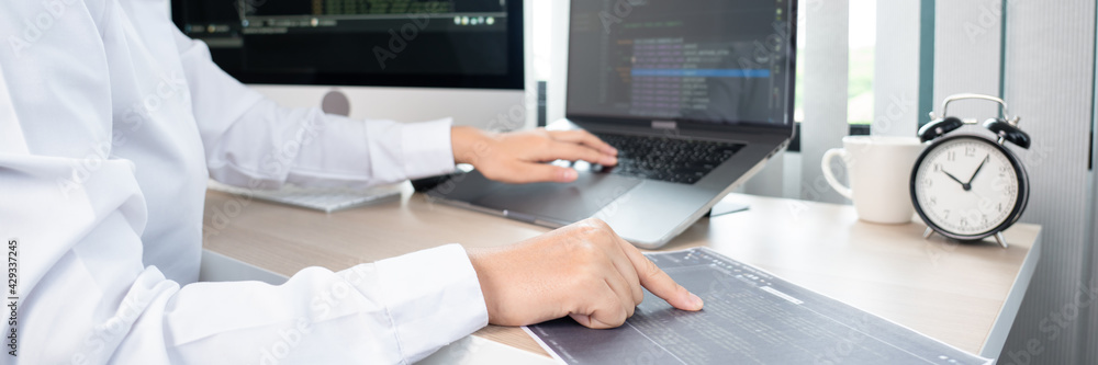 Asian Woman programmer typing source codes Programming On Computer in office, freelance web developer concept. Asian Woman programmer typing source codes Programming On Computer in office, freelance web developer concept.