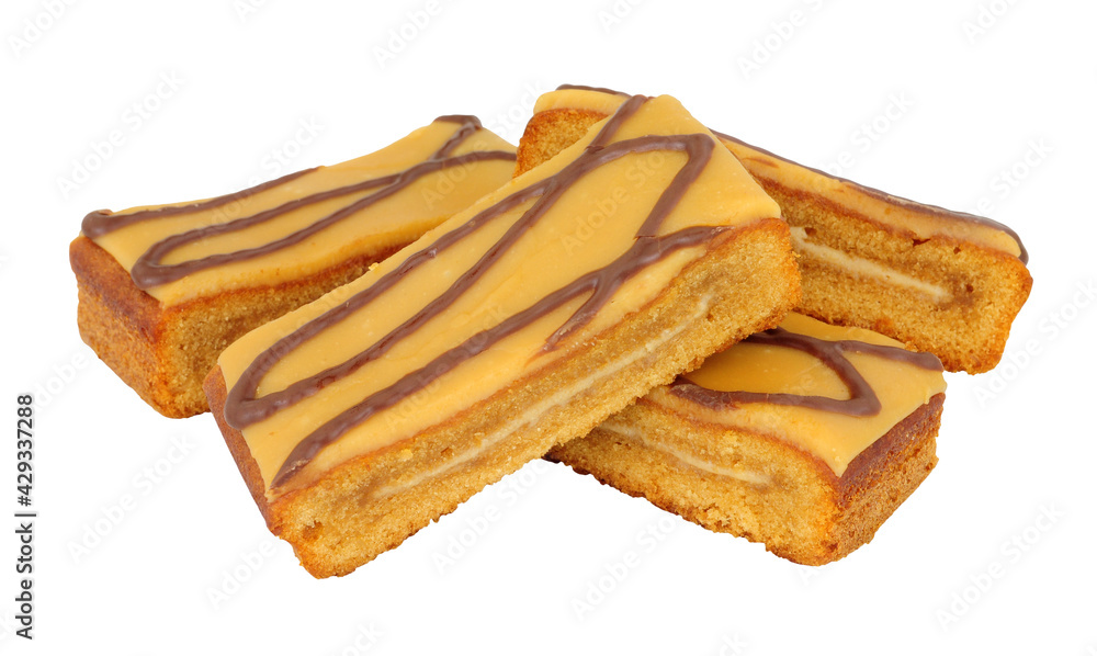 Caramel flavour sponge cake slices topped with salted caramel icing isolated on a white background Caramel flavour sponge cake slices topped with salted caramel icing isolated on a white background