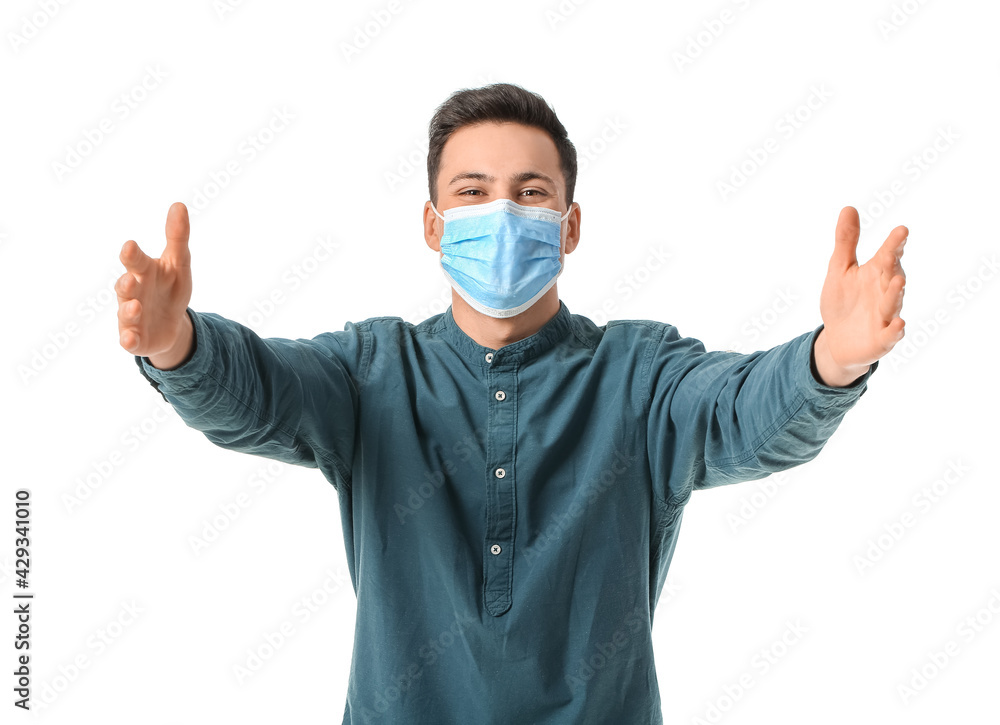 Young man in medical mask opening arms for hug on white background Young man in medical mask opening arms for hug on white background