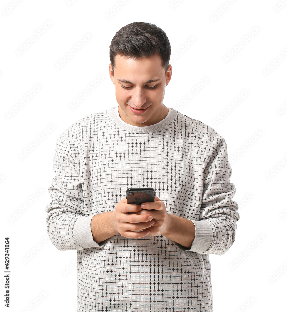 Handsome young man with mobile phone on white background