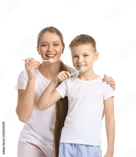 Mother and little son brush...