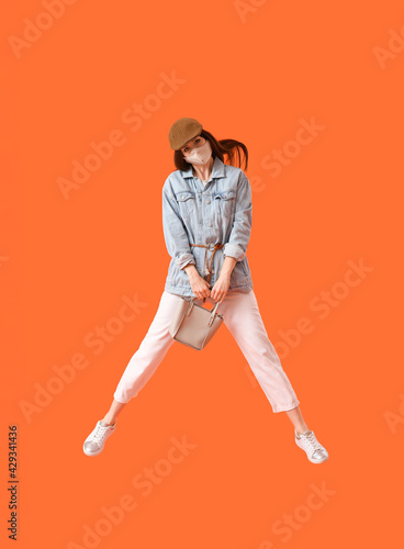 Jumping fashionable young w...