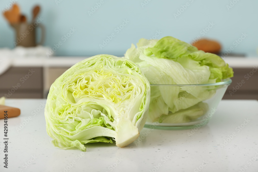 Iceberg lettuce on table in kitchen, closeup Iceberg lettuce on table in kitchen, closeup