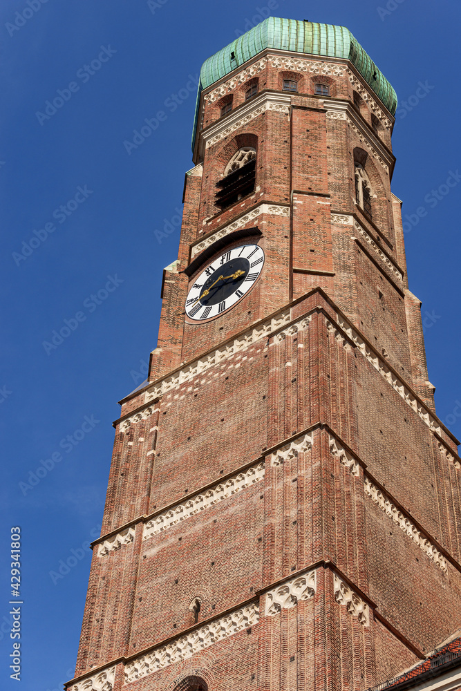 Close-up of one of the two bell towers of the Munich Cathedral in gothic style (1468-1488). Frauenkirche or Cathedral of Our Lady (Dom zu Unserer Lieben Frau). Bavaria, Germany, Europe.