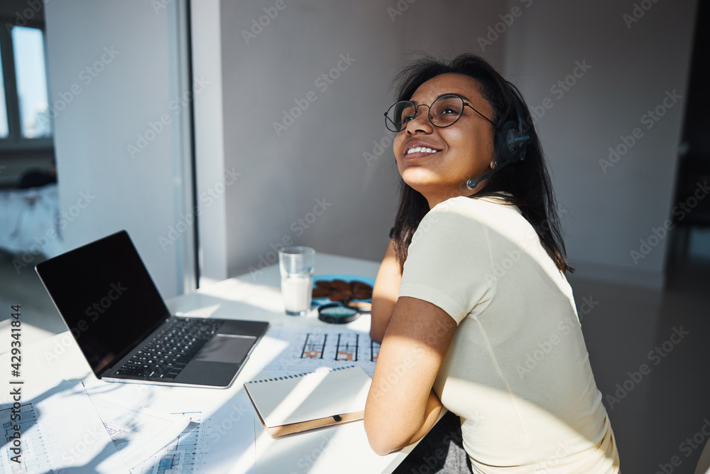 Cheerful young woman working on project at home Cheerful young woman working on project at home