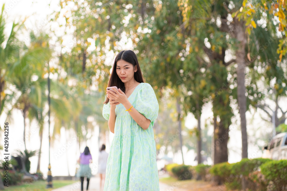 Portrait of asian beautiful women talking on smartphone in outdoor park Portrait of asian beautiful women talking on smartphone in outdoor park