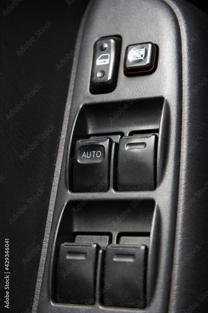 Generic car power windows adjustment switch panel close up shot