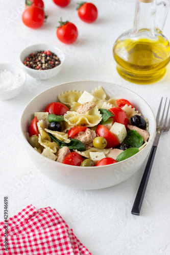 Pasta salad with tuna, tomatoes and white cheese. Farfalle. Healthy eating. Diet.