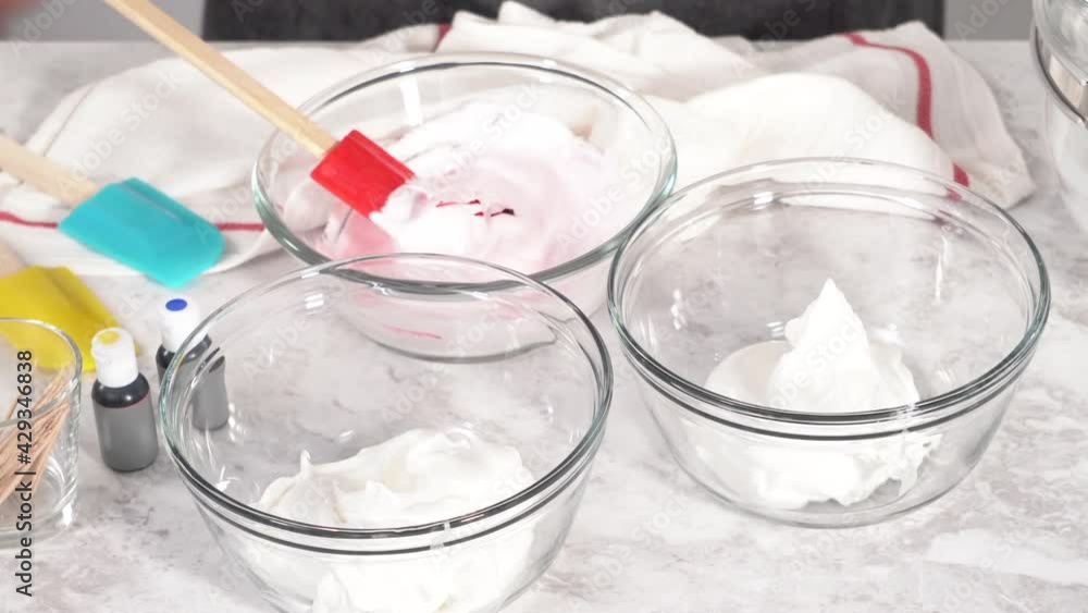 Step by step. Mixing in food coloring into the meringue to bake unicorn meringue pops cookies. Step by step. Mixing in food coloring into the meringue to bake unicorn meringue pops cookies.