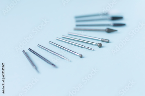 A set of cutters for hardware manicure and pedicure on a light background. Close-up. Space for text