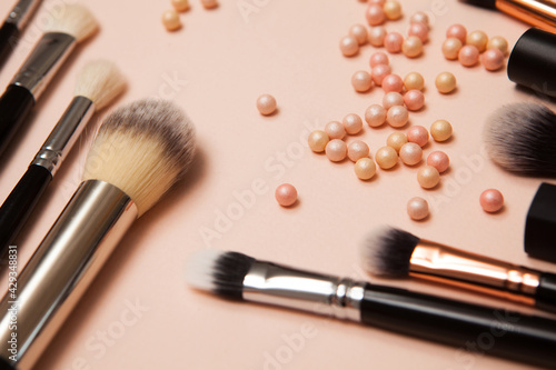 Various cosmetic brushes on pink background. Makeup brushes set for take care skin.