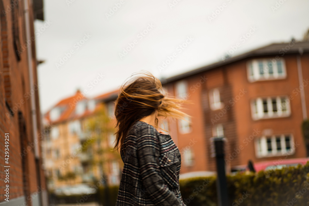 Woman on the street. Focus is on woman.  Girl with long hair.