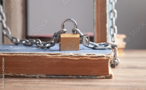 Book with chain and padlock. Information security