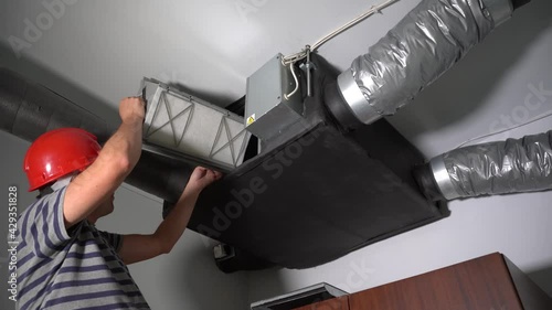 Professional Guy Install Filter for Home Central Air Recuperation System