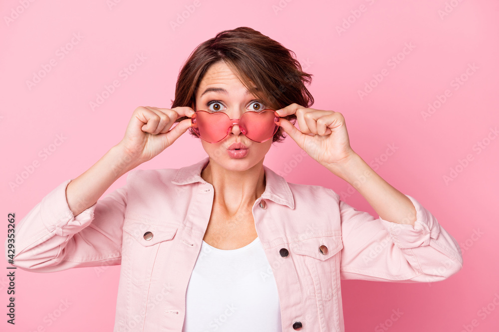 Photo of amazed funky attractive woman wear sunglass pouted lips shocked isolated on pink color background Photo of amazed funky attractive woman wear sunglass pouted lips shocked isolated on pink color background