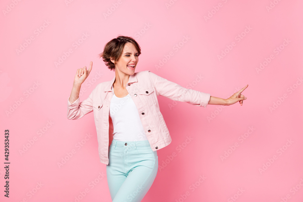 Photo portrait of dancing woman isolated on pastel pink colored background Photo portrait of dancing woman isolated on pastel pink colored background