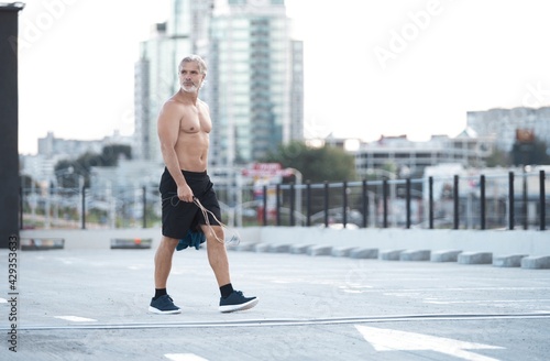 Tired Exhausted Athletic Middle-aged Man In Sportswear Walking After Fitness Workout And Exercising