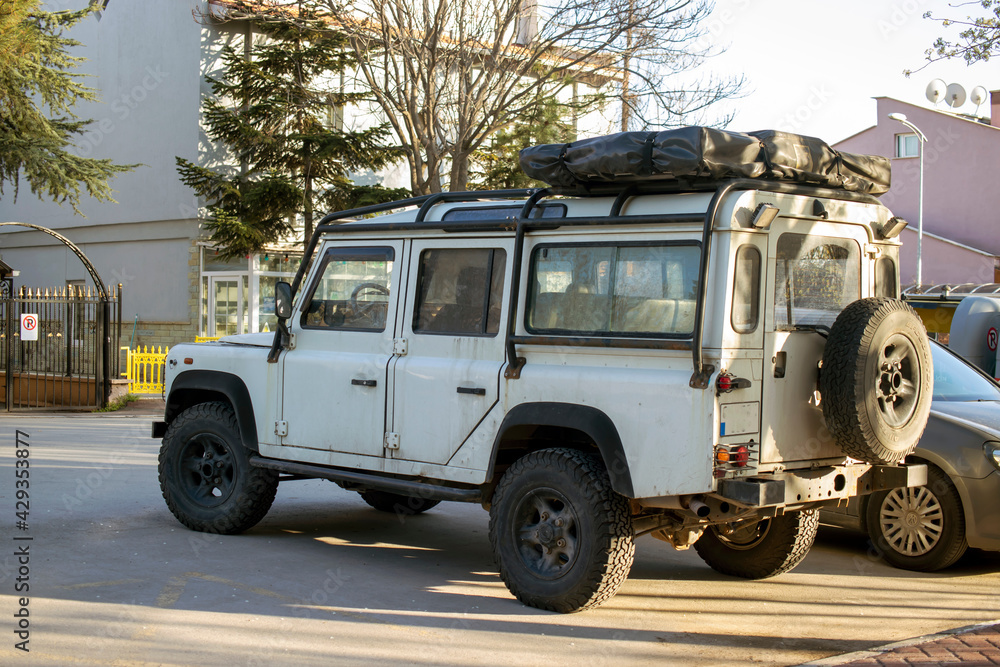 
4 * 4 off-road car, off-road white vehicle with dirty dust and mud.