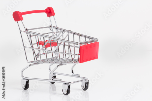 Empty metallic supermarket shopping cart side view isolated. Realistic supermarket basket, retail pushcart vector illustration stock illustration © Chillapuram