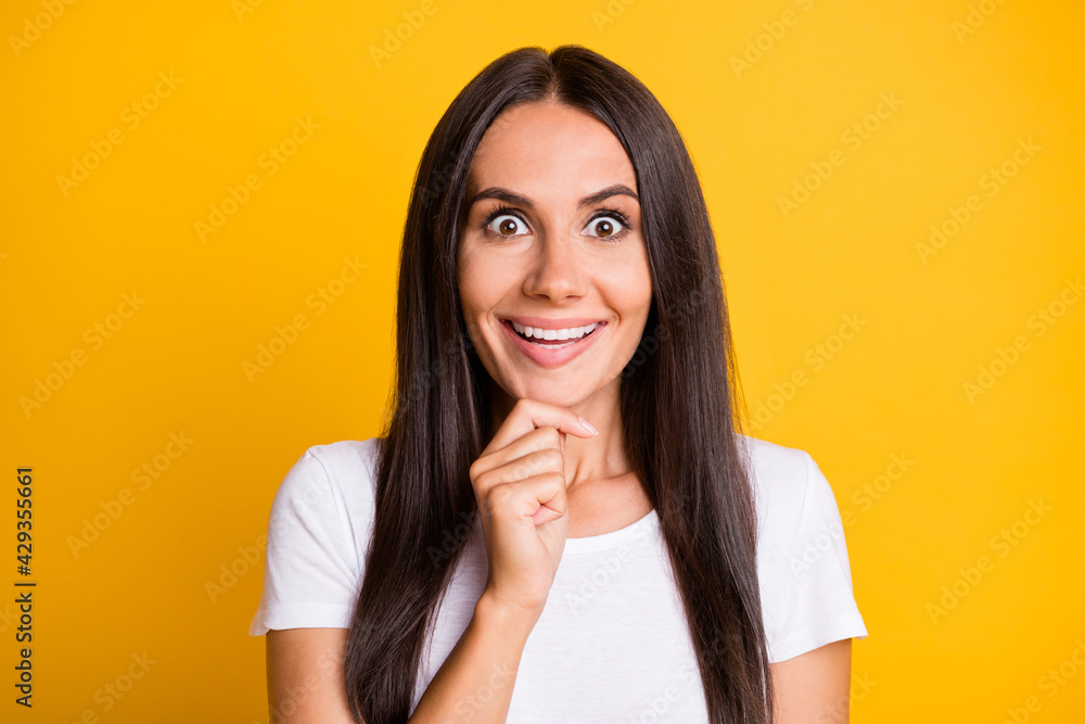 Photo of pretty excited young woman dressed white t-shirt big eyes arm chin isolated yellow color background