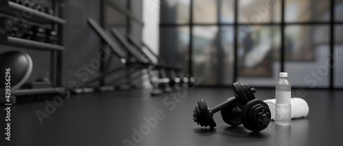 3D rendering, dumbbells on the floor in concept fitness room with training equipments in the back