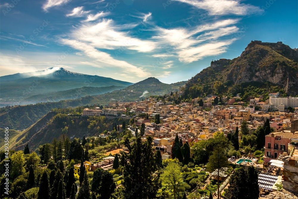 View of the historical town of Taormina and Mt. Etna in the distance 