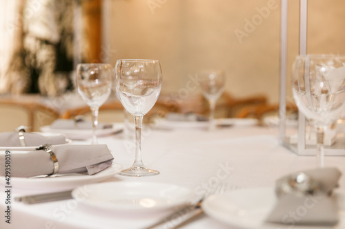 Festive Floral decor on wedding banquet tables in white colors with cutlery