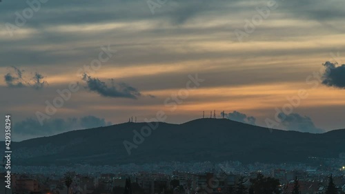 Sunset timelapse of Egaleo mountain with telephone towers near Athens, Greece photo