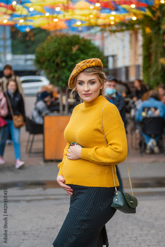 pregnant woman walking in the street