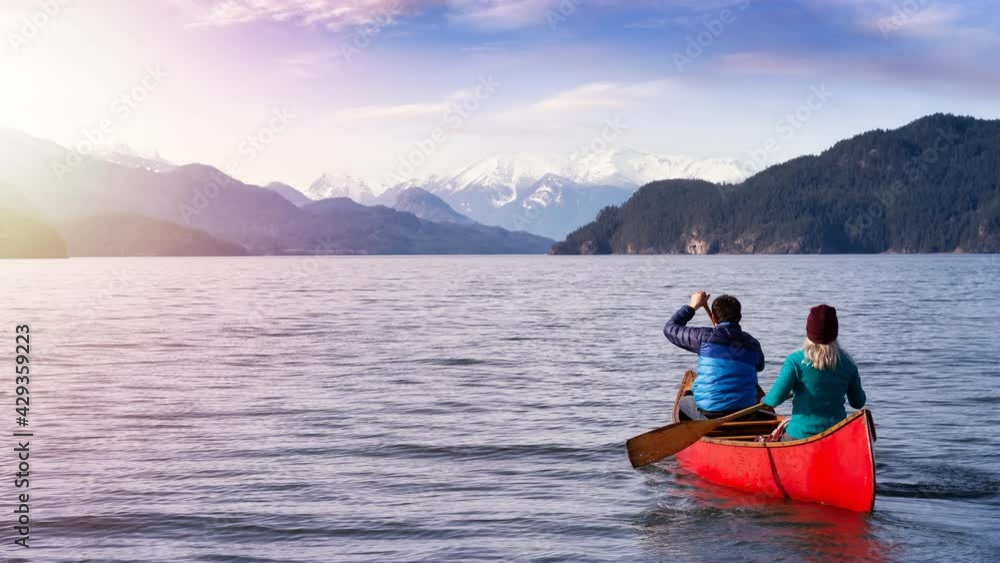 Cinemagraph Seamless Continuous Loop Animation. Couple friends canoeing on a wooden canoe during a sunny day. Taken in Harrison Lake, East of Vancouver, British Columbia, Canada. Cinemagraph Seamless Continuous Loop Animation. Couple friends canoeing on a wooden canoe during a sunny day. Taken in Harrison Lake, East of Vancouver, British Columbia, Canada.