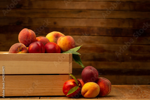 Peaches on wooden background in studio