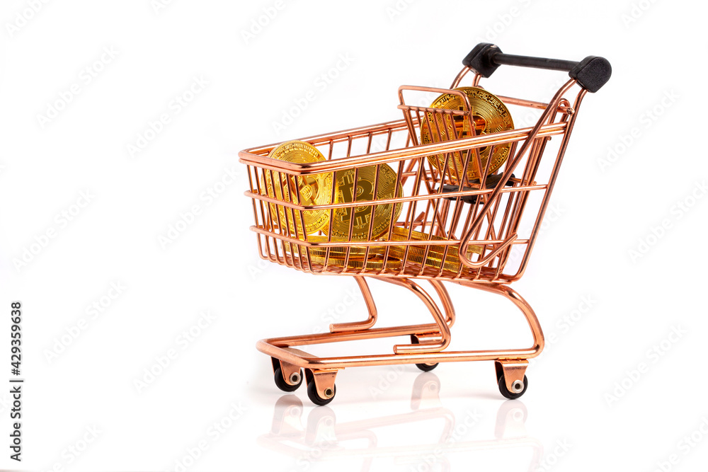 Bitcoin in shopping cart. Black background stock photo