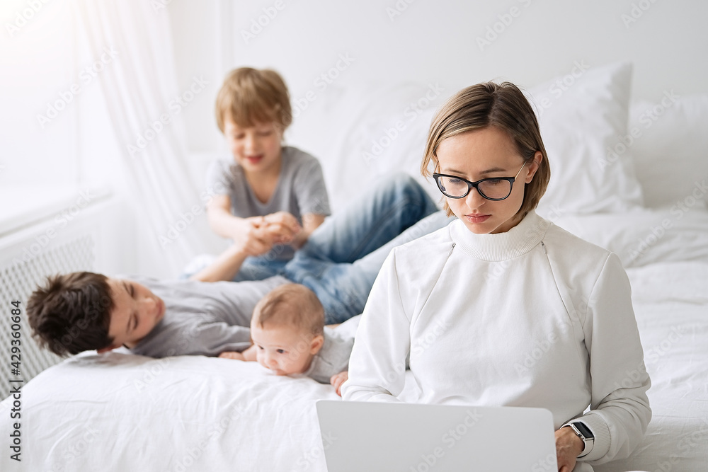 Work from home. Mother working with children and laptop computer at home. Quarantine and closed school during coronavirus outbreak. Work from home. Mother working with children and laptop computer at home. Quarantine and closed school during coronavirus outbreak.