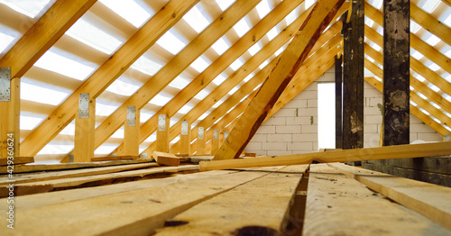 Bild auf Leinwand roof construction - a wooden roof frame covered with a waterproofing film, fixin