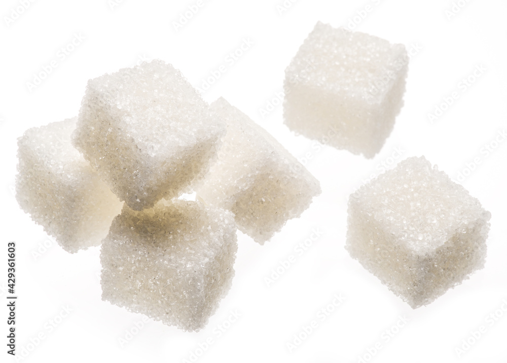 White sugar cubes on white background. Macro picture. White sugar cubes on white background. Macro picture.