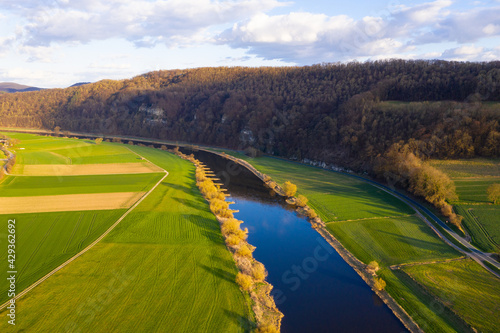 View of drone of landscape of river Weser and village Doelme in Germany .