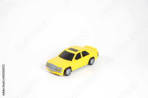 Toy plastic car isolated on white background. Yellow car.