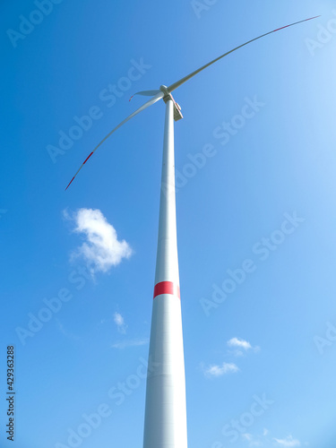 Windmill against blue sky in sunshine