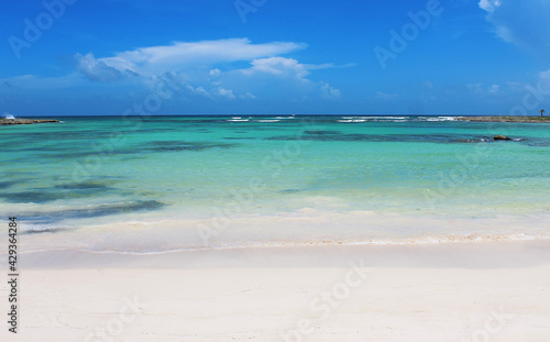 Fototapeta Naklejka Na Ścianę i Meble -  Beautiful white sandy beach and turquoise waters of Caribbean sea in summer sunny day. Caribbean coast in the Playa del Carmen, Riviera Maya, Quintana Roo, Mexico. Soft focus