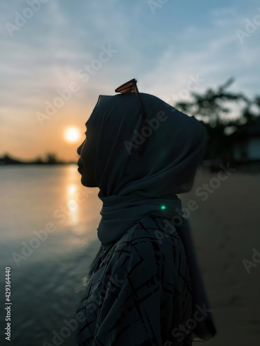 A Lonely Woman in front of Sunset at Beautiful Beach