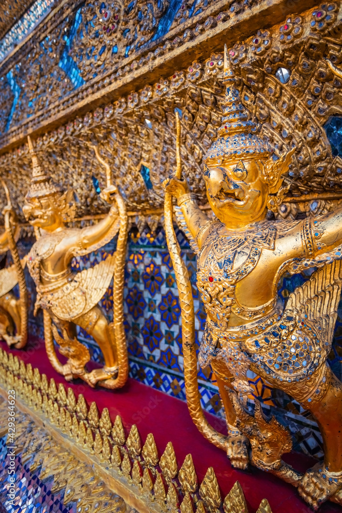 Details on the base of the Wat Phra Kaew's main hall - a sacred temple whic is a part of the Thai grand palace, where it houses an ancient Emerald Buddha